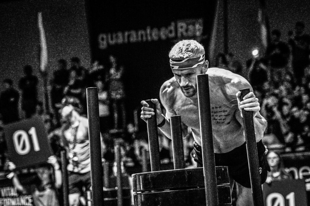 Pro athlete pushing the HYROX sled