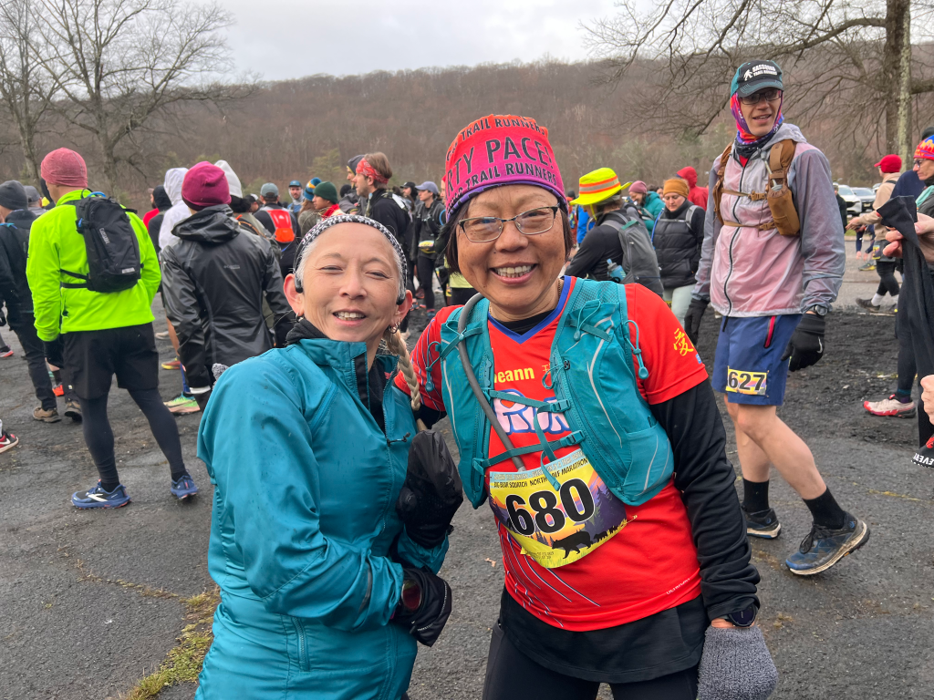 Two runners in winter kit celebrating at the finish of Big Bear SquaTCh North, Bear Mountain NY