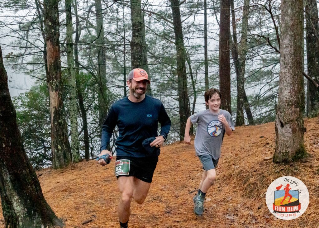 Two runners on a leaf-strewn forest trail near Helen, Georgia