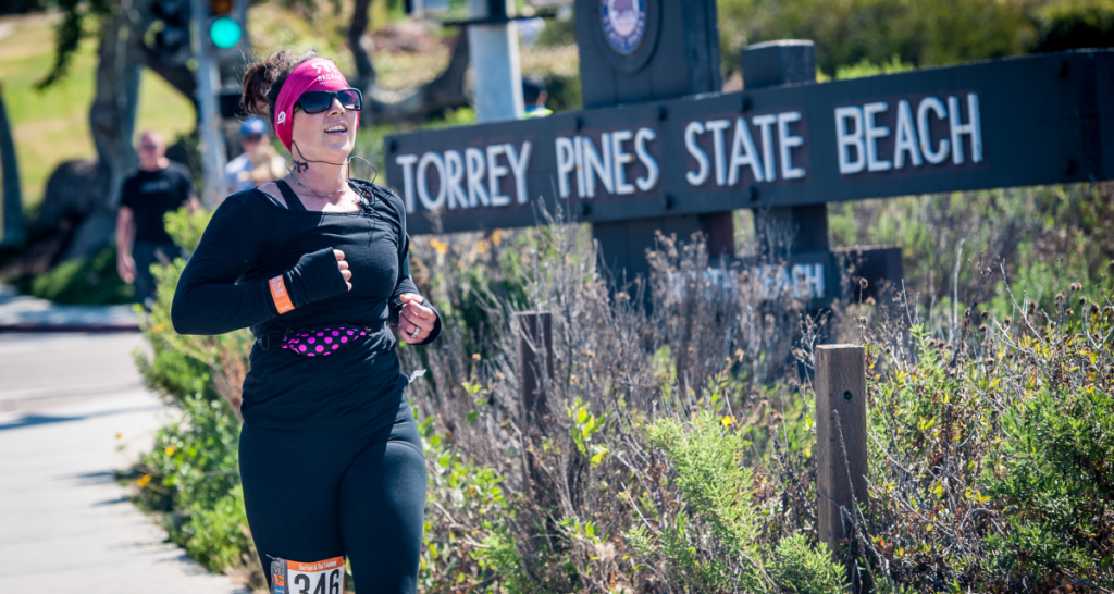 Runner passing the Torrey Pines State Beach sign during Ragnar Road SoCal
