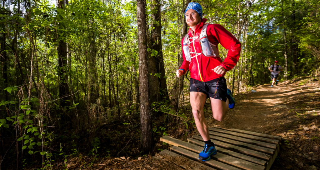 Runner descending singletrack at Ragnar Trail Arkansas