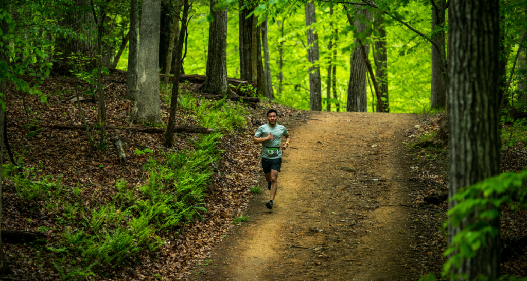Runner on a forest singletrack trail at Ragnar Trail Michigan