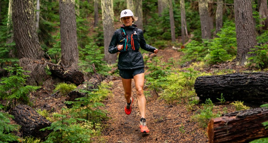 Runner on a forested mountain trail at Ragnar Trail South Cascades
