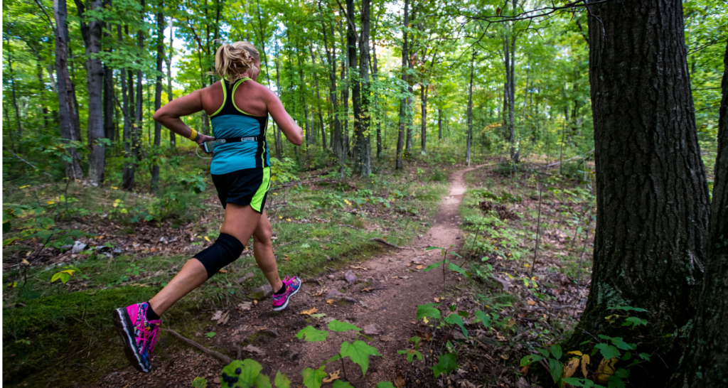 Trail runner on a wooded singletrack trail at Ragnar Trail Wisconsin