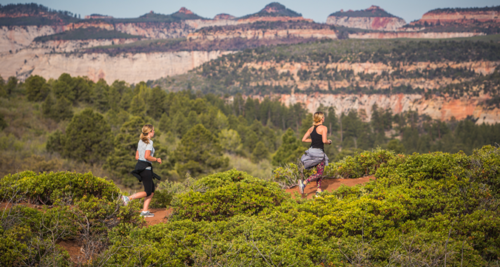 Runners on a red rock desert trail at Ragnar Trail Zion