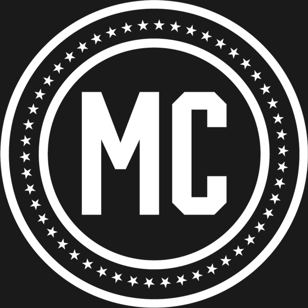 MAN CAMP circular MC emblem in white on a dark background