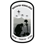 Mountain Man Memorial March oval patch logo with a battlefield cross and the motto Honor Through Action