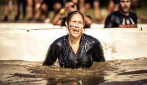 Tough Mudder participants navigating a muddy obstacle at a past Toronto event